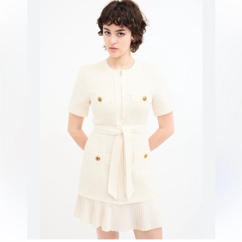 Elegant ivory or cream colored short sleeve mini tweed dress with pleated bottom